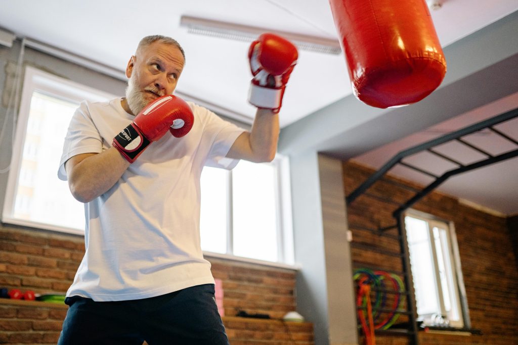 Active older man boxing, representing strong physical health and a youthful biological age.